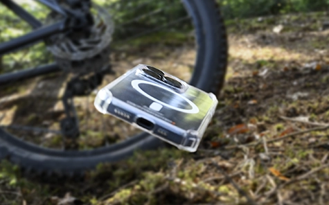 Mobile phone in protection case is falling on a forestal floor