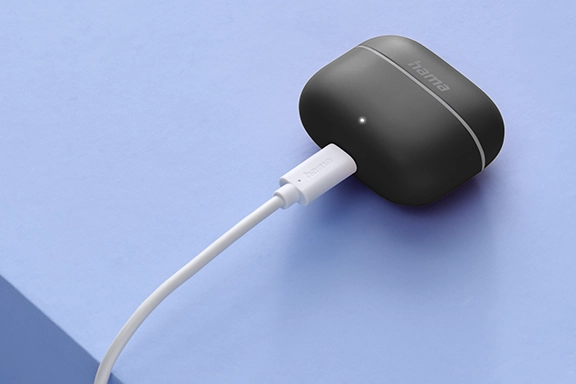 Freedom Light II Bluetooth headphones with charging case are charged.