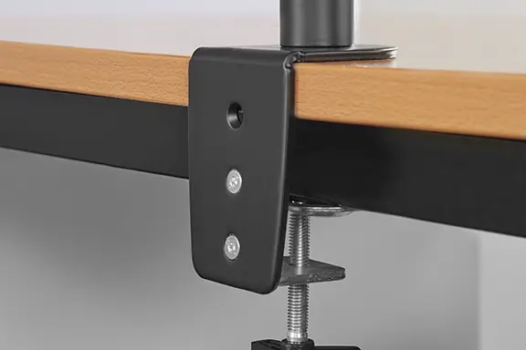 Monitor arm mounted on desk.